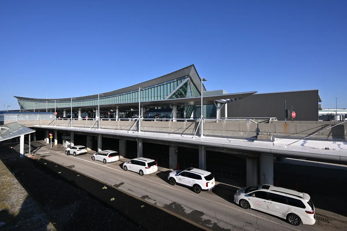 Buffalo Niagara International Airport terminal with taxis at the curbside pickup lane