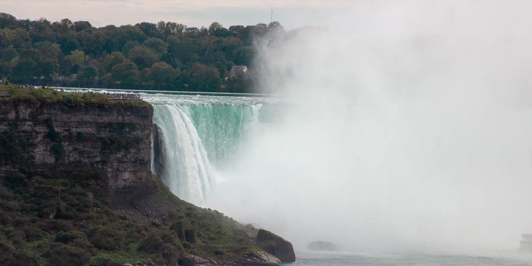 Niagara Falls with mist rising from the horseshoe falls, a popular day trip from Toronto